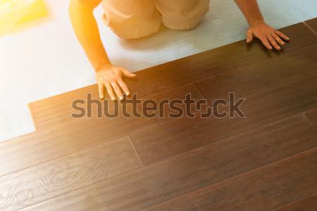Man Installing New Laminate Wood Flooring Stock photo © feverpitch