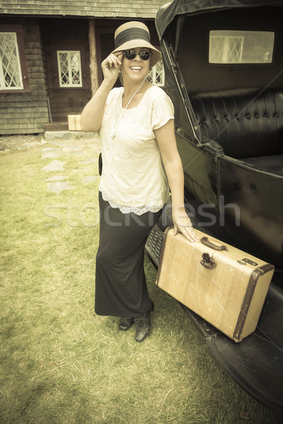 Happy 1920s Dressed Girl Holding Suitcase Next to Vintage Car Stock photo © feverpitch