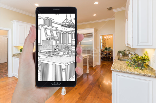 Hand Holding Smart Phone Displaying Drawing of Kitchen Photo Beh Stock photo © feverpitch