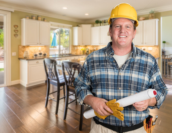 Contractor With Plans and Hard Hat Inside Custom Kitchen. Stock photo © feverpitch