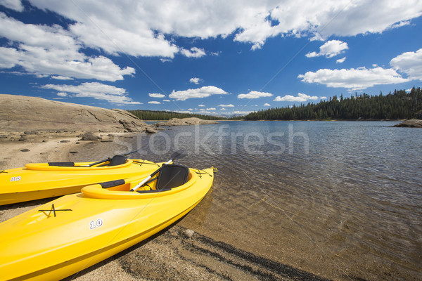 Pair of Yellow Kayaks on Beautiful Mountain Lake Shore. Stock photo © feverpitch