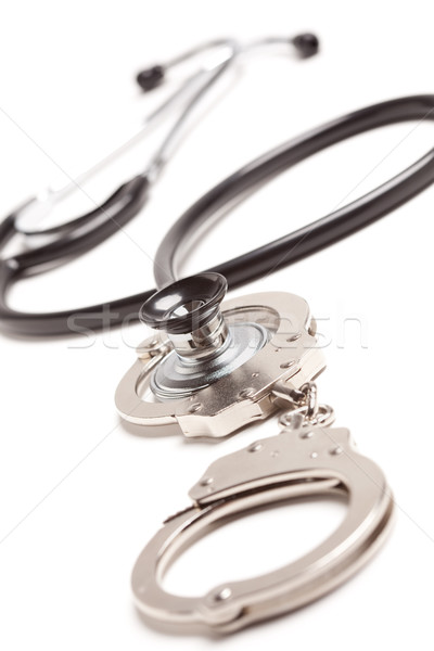 Stethoscope and Handcuffs on White Stock photo © feverpitch