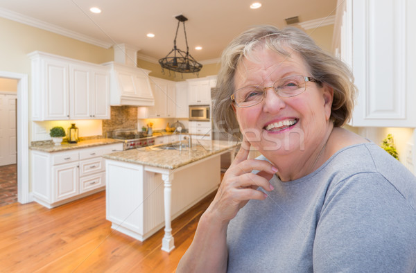 Happy Senior Woman In Custom Kitchen Interior Stock photo © feverpitch