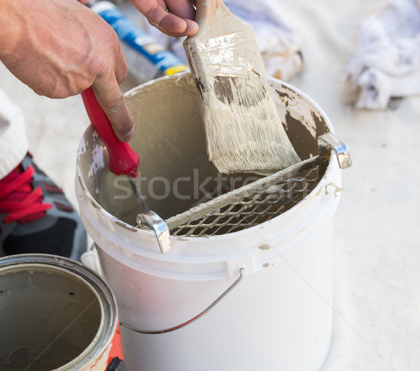 Professional Painter Loading Paint Onto Brush From Bucket Stock photo © feverpitch