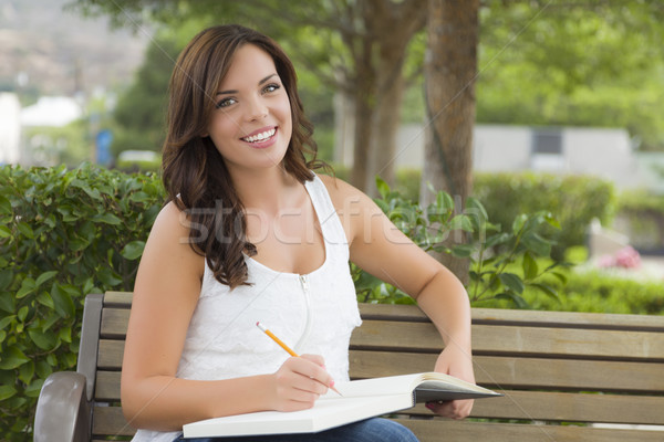 Young Adult Female Student on Bench Outdoors Stock photo © feverpitch