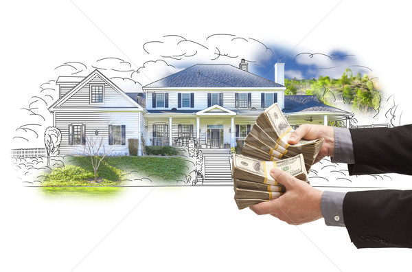 Hand Holding Thousands In Cash Over House Drawing and Photo Stock photo © feverpitch