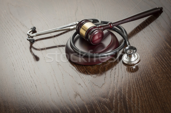 Gavel and Stethoscope on Reflective Table Stock photo © feverpitch