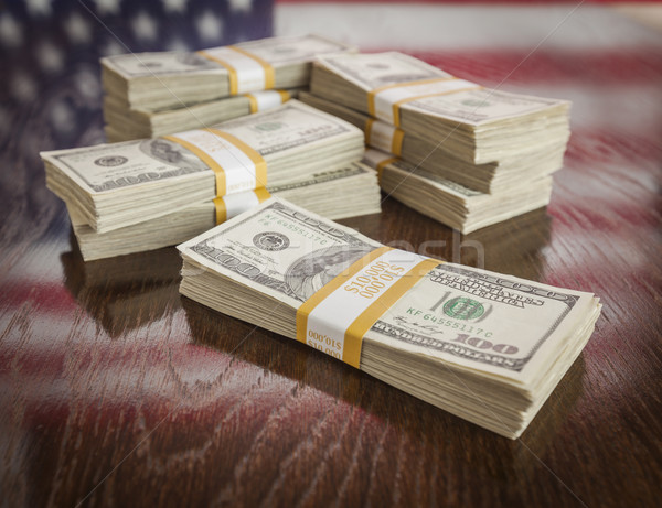 Thousands of Dollars with Reflection of American Flag on Table Stock photo © feverpitch