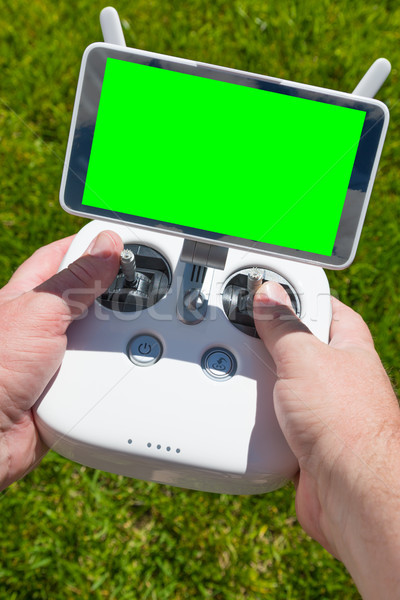 Hands Holding Drone Quadcopter Controller With Blank Green Scree Stock photo © feverpitch