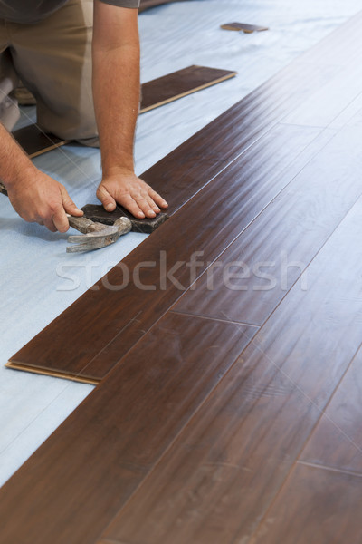 Man Installing New Laminate Wood Flooring Stock photo © feverpitch