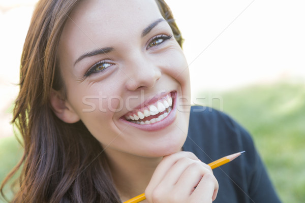 Portrait of Pretty Young Female Student with Pencil on Campus Stock photo © feverpitch