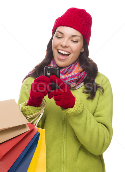 Mixed Race Woman Holding Shopping Bags Texting On Cell Phone  Stock photo © feverpitch