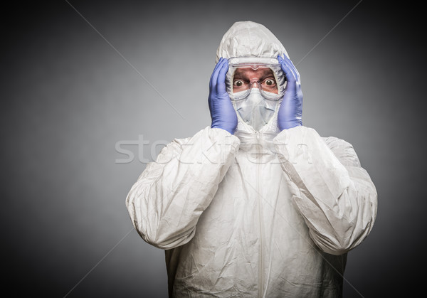 Man Holding Head With Hands Wearing HAZMAT Protective Clothing A Stock photo © feverpitch