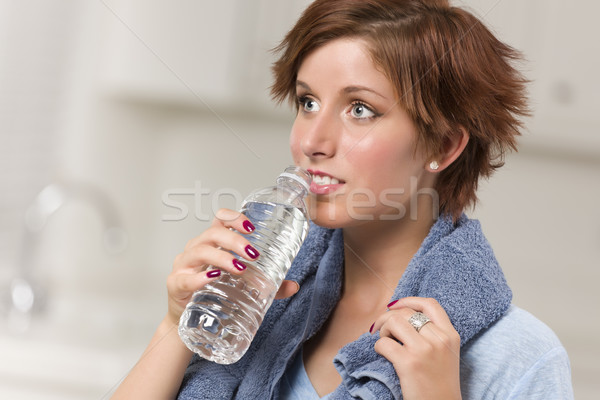 Pretty Red Haired Woman with Towel Drinking From Water Bottle Stock photo © feverpitch