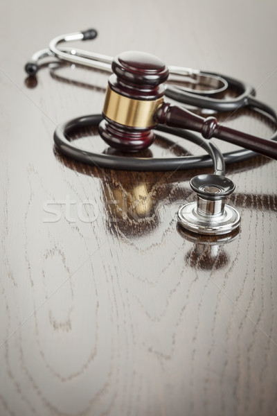 Gavel and Stethoscope on Reflective Table Stock photo © feverpitch