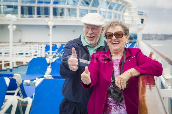 Senior Couple With Thumbs Up on Deck of Cruise Ship Stock photo © feverpitch