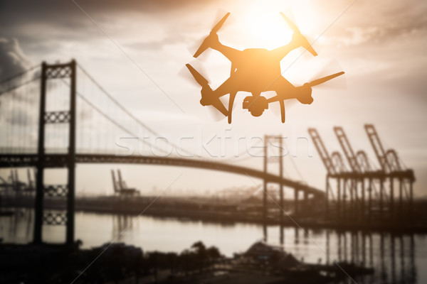 Silhouette of Unmanned Aircraft System (UAV) Quadcopter Drone In Stock photo © feverpitch