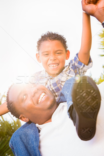 Mixed Race Son and African American Father Playing Piggyback Out Stock photo © feverpitch