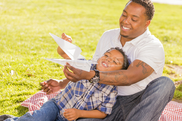 Mixed Race Father and Son Playing with Paper Airplanes Stock photo © feverpitch