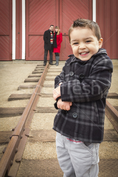 Mixed Race Boy at Train Depot with Parents Smiling Behind Stock photo © feverpitch