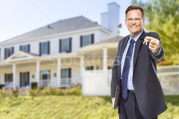 Real Estate Agent with House Keys in Front of Home Stock photo © feverpitch