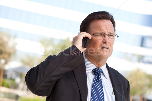 Concerned Businessman Talks on His Cell Phone Stock photo © feverpitch
