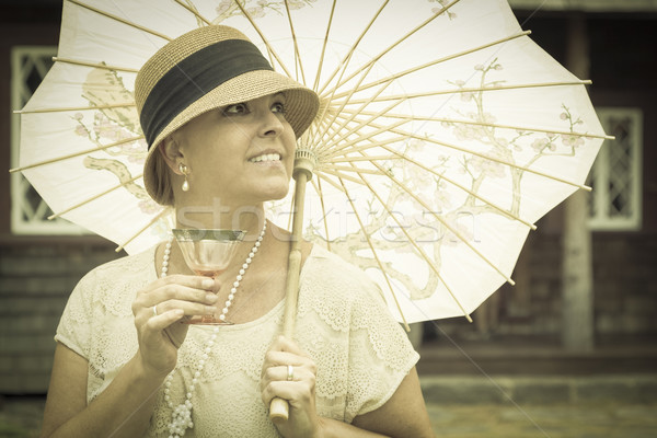 Stock photo: 1920s Dressed Girl with Parasol and Glass of Wine Portrait