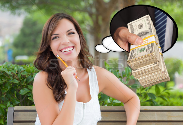 Thoughtful Young Woman with Hand Holding Stack of Money Inside T Stock photo © feverpitch