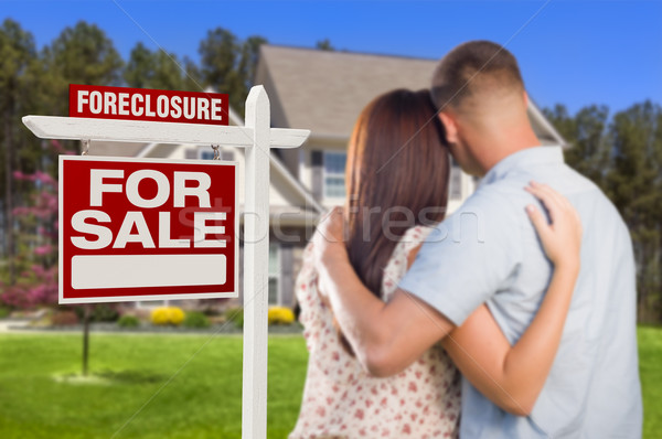 Military Couple Standing in Front of Foreclosure Sign and House Stock photo © feverpitch