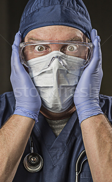 Stunned Doctor or Nurse with Protective Wear and Stethoscope Stock photo © feverpitch