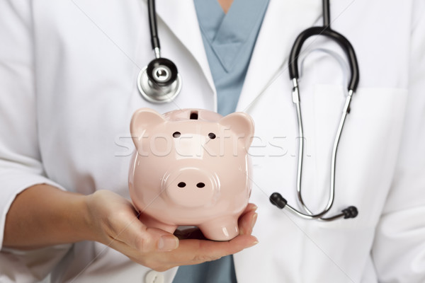 Doctor with Stethoscope Holding Piggy Bank Abstract Stock photo © feverpitch
