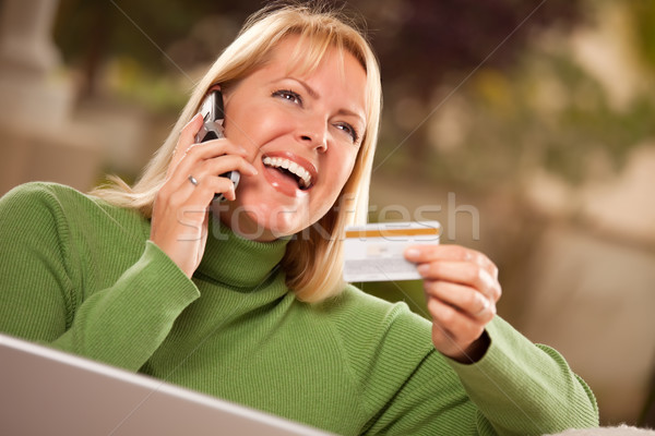 Cheerful Woman on Phone and Laptop with Credit Card Stock photo © feverpitch