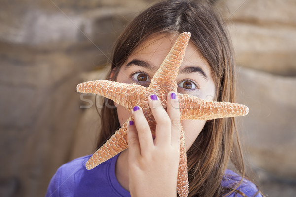 Stock photo: Young Girl Playing with Starfish