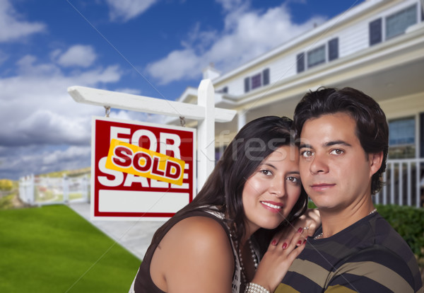 Hispanic Couple, New Home and Sold Real Estate Sign Stock photo © feverpitch