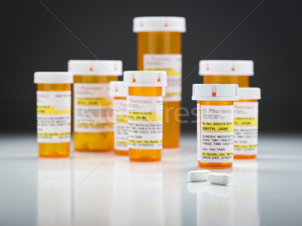 Médecine bouteilles pilules réfléchissant surface gris Photo stock © feverpitch