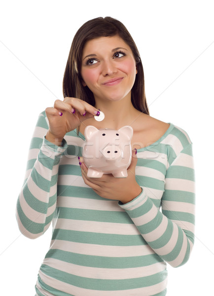 Ethnic Female Putting Coin Into Piggy Bank on White Stock photo © feverpitch