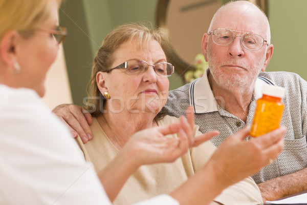 Stock photo: Doctor or Nurse Explaining Prescription Medicine to Senior Coupl
