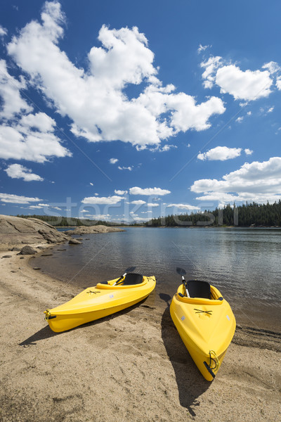 Pair of Yellow Kayaks on Beautiful Mountain Lake Shore. Stock photo © feverpitch