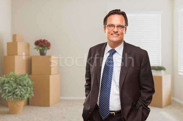 Businessman in Empty Room with Packed Boxes and Plants Stock photo © feverpitch