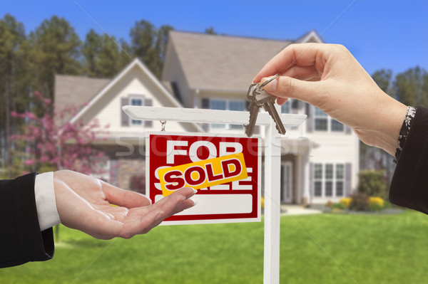 Stock photo: Agent Handing Over the House Keys in Front of New Home
