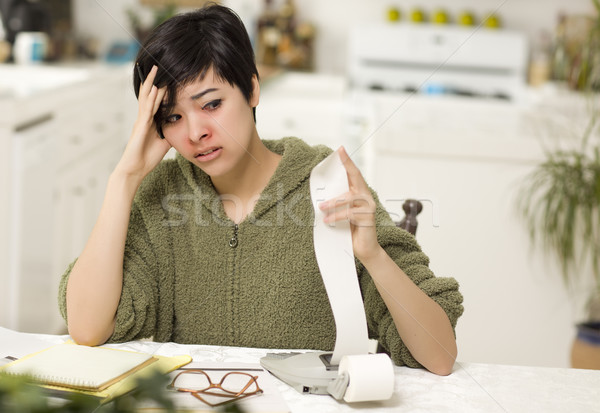 Stock photo: Multi-ethnic Young Woman Agonizing Over Financial Calculations