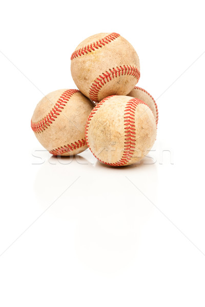 Four Baseballs Isolated on Reflective White Stock photo © feverpitch