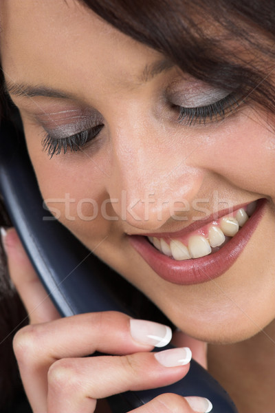 Mulher de negócios formal terno preto falante telefone olhando para baixo Foto stock © Forgiss