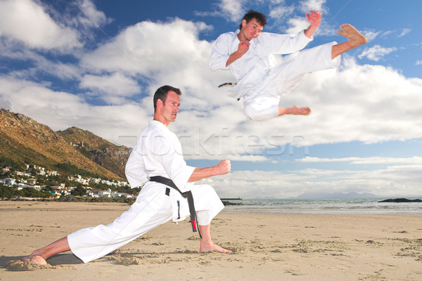 Men practicing Karate on the beach Stock photo © Forgiss