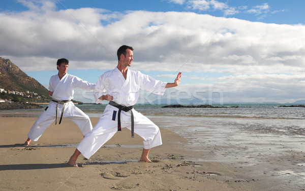 Men practicing Karate on the beach Stock photo © Forgiss