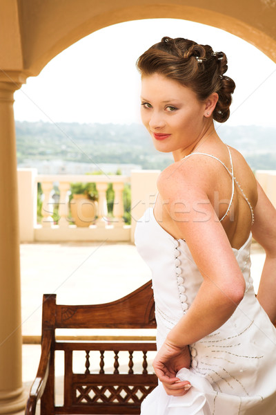Sexy young brunette bride wearing white wedding gown Stock photo © Forgiss