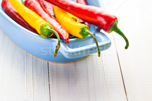 Színes paprikák kék tál tűz fa Stock fotó © fotoaloja
