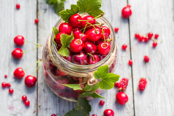 Glass jar full of fruits cherries and currants Stock photo © fotoaloja