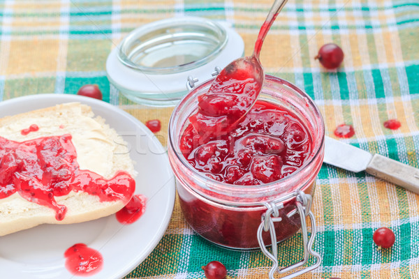 Stock photo: Scooping gooseberry jam jar spoon