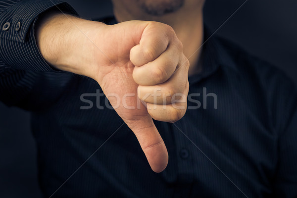 Közelkép férfi kéz mutat hüvelykujjak lefelé Stock fotó © fotoaloja
